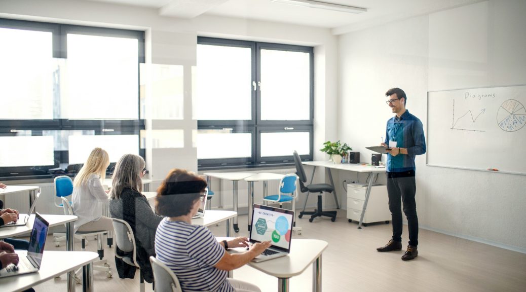 Group of senior people attending computer and technology education class