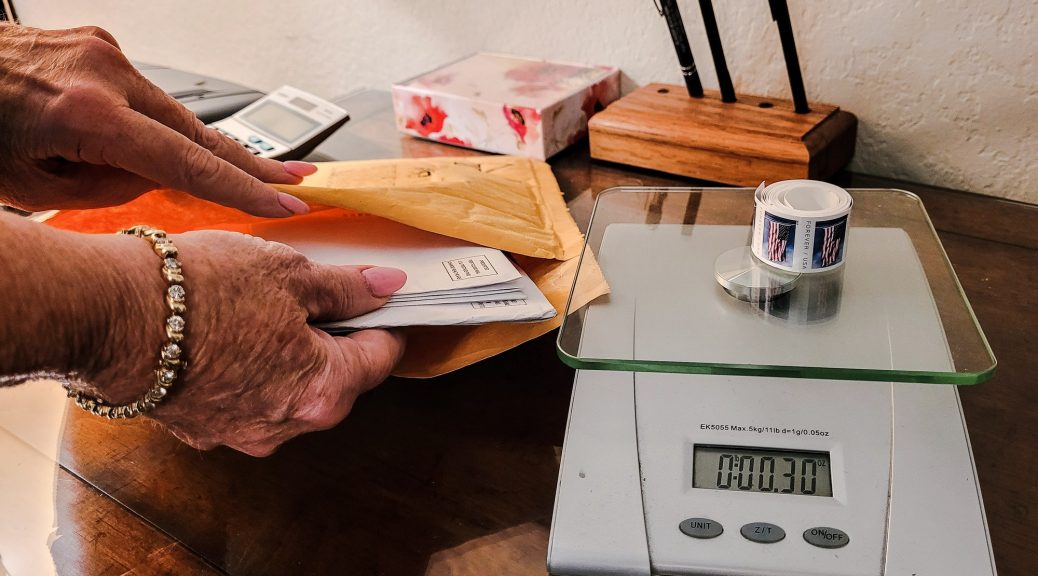 Mailing letters with proper postage due using package scale in workspace.