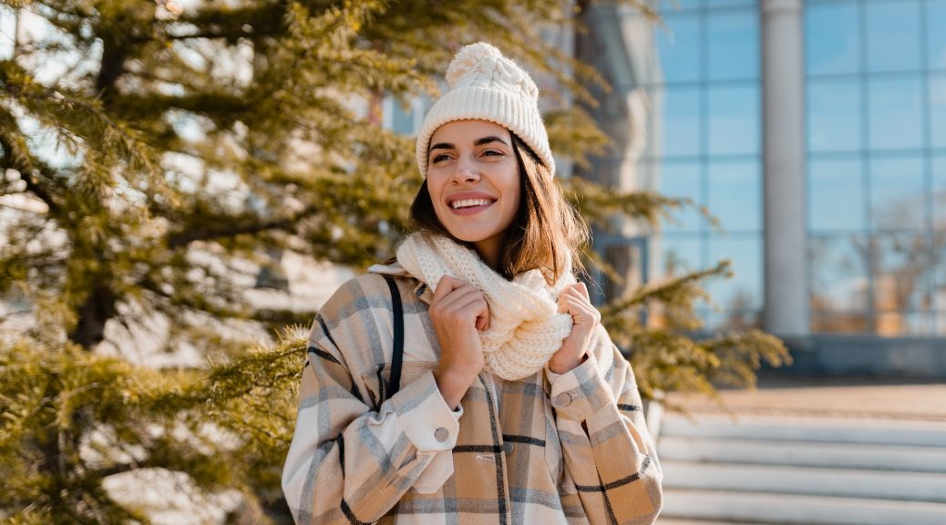 young smiling woman walking in street in winter
