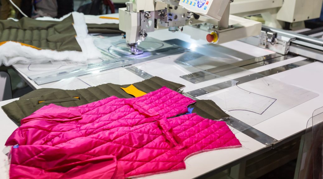 Sewing machine in cutting shop on clothing factory